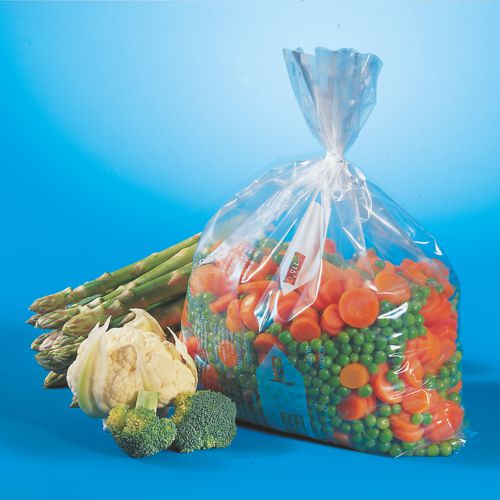 Un sac de congélation transparent Starpak 45 (LLDPE, 6 l, 46 x 30 cm), rempli de carottes coupées et de petits pois verts, est présenté à côté d'asperges fraîches, de chou-fleur et de brocoli - idéal pour le stockage au congélateur. Boîte pliante (45 pièces).