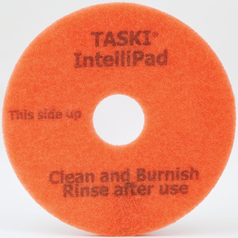 Ein orangefarbenes rundes TASKI Intellipad Kombiniertes Reinigungs- und Polierpad für Unterhaltsreinigung von Diversey Deutschland GmbH & Co. OHG, mit zentralem Loch und Text: "TASKI Intellipad", "Diese Seite nach oben", "Reinigen und Polieren Nach Gebrauch ausspülen.