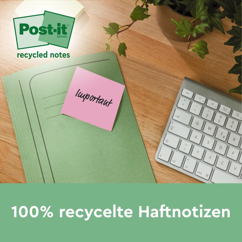 Une note de recyclage Post-it® rose (76 x 127 mm, 100 feuilles, 100% PEFC) de 3M Deutschland GmbH avec l'inscription "important" est attachée à un classeur vert sur un bureau en bois à côté d'un clavier et d'une plante. Texte : "Notes adhésives 100% recyclées."
