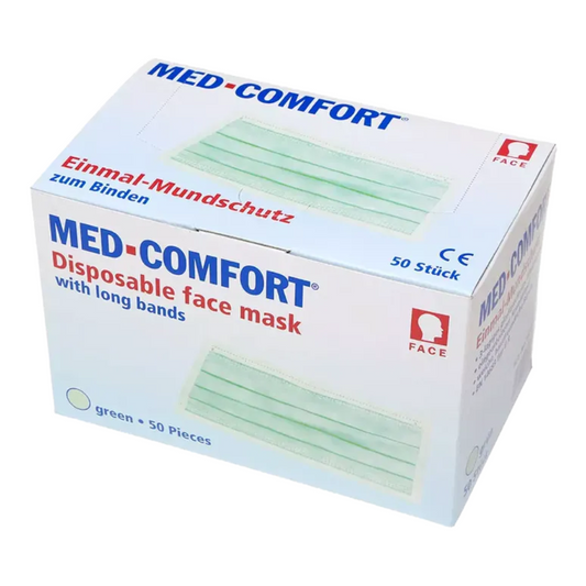 Eine weiße Schachtel mit der Aufschrift „AMPri MED-COMFORT OP Maske zum Binden Typ IIR“ in blauer und roter Schrift, die 50 grüne Masken der AMPri Handelsgesellschaft mbH enthält. Auf der Schachtel sind CE- und produktbezogene Symbole sowie der deutsche Text „Mundschutz Einwegprodukt zum Binden“ zu sehen.