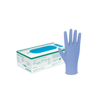 Une boîte B. Braun La photo représente des gants d'examen Vasco® en nitrile bleus à bord roulé, destinés à un usage médical. À côté, un gant est représenté debout. Sur la boîte figurent du texte et des illustrations présentant les spécifications détaillées et les marques déposées de B. Braun Deutschland GmbH & Co. KG, qui sont clairement étiquetés « sans latex ».
