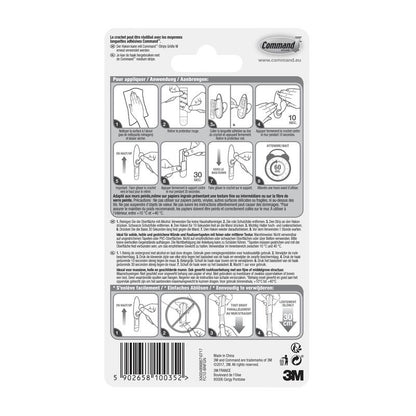 Arrière de l'emballage des crochets en métal Command™ "classique" (3M Deutschland GmbH) avec un guide d'application et de retrait illustré multilingue ainsi qu'un code-barres en bas.
