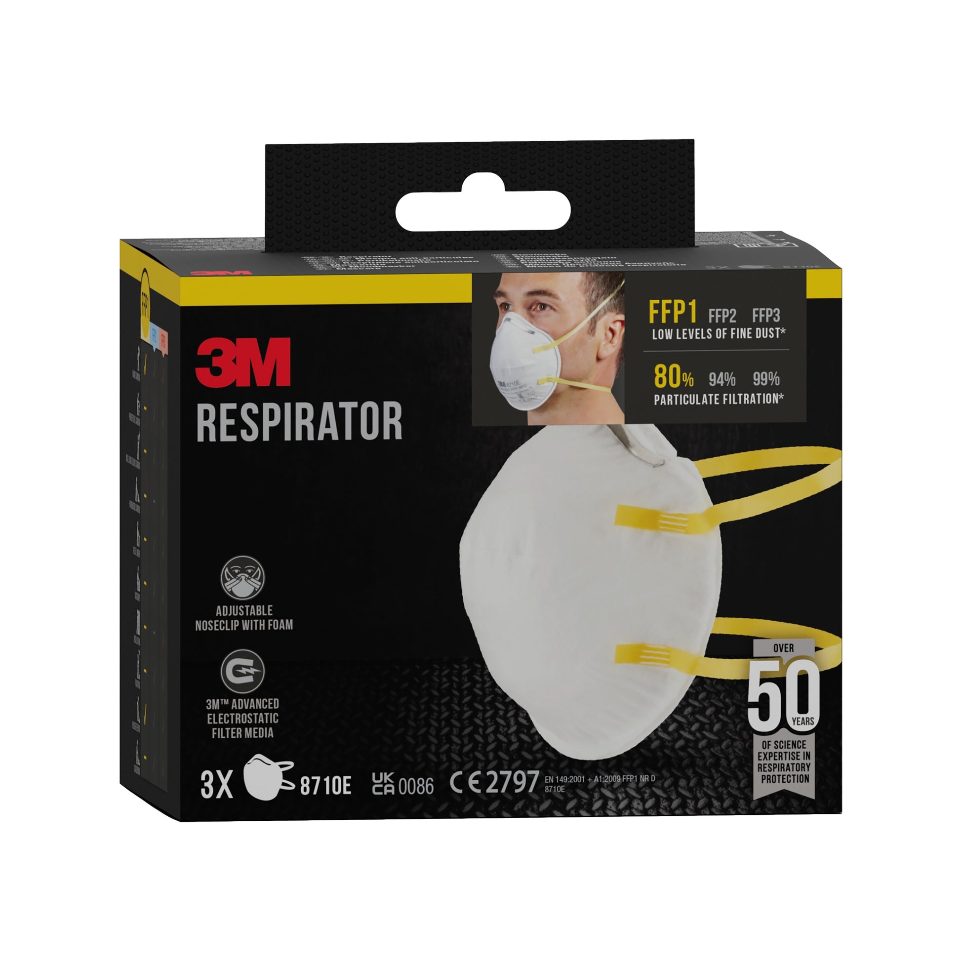 Eine schwarze Schachtel der 3M™ Partikelmaske 8710E, FFP1, ohne Ventil von 3M Deutschland GmbH zeigt eine Person, die eine weiße Maske mit gelben Bändern trägt; die Schachtel enthält 3 Masken und hebt den FFP1-Schutz gegen Feinstaub hervor.